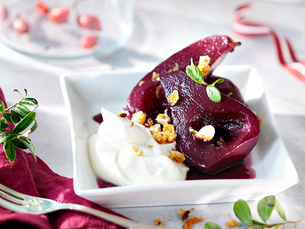 Wine-poached pears with cream cheese and roasted hazelnuts